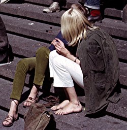 Young woman wearing a well-used combat jacket on the steps of The Royal Swedish Opera in 1965 Young woman wearing a well-used combat jacket on the steps of The Royal Swedish Opera in 1965