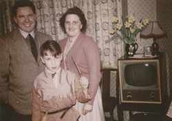 Family in front of television set, 1950s